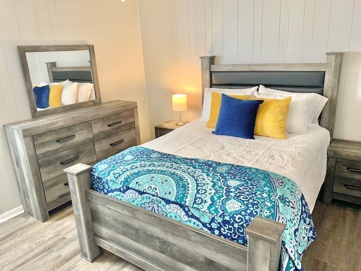 a bedroom with a bed and two dressers