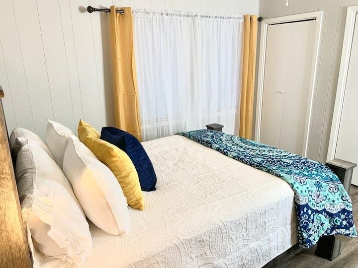 a bedroom with a large bed with pillows on it