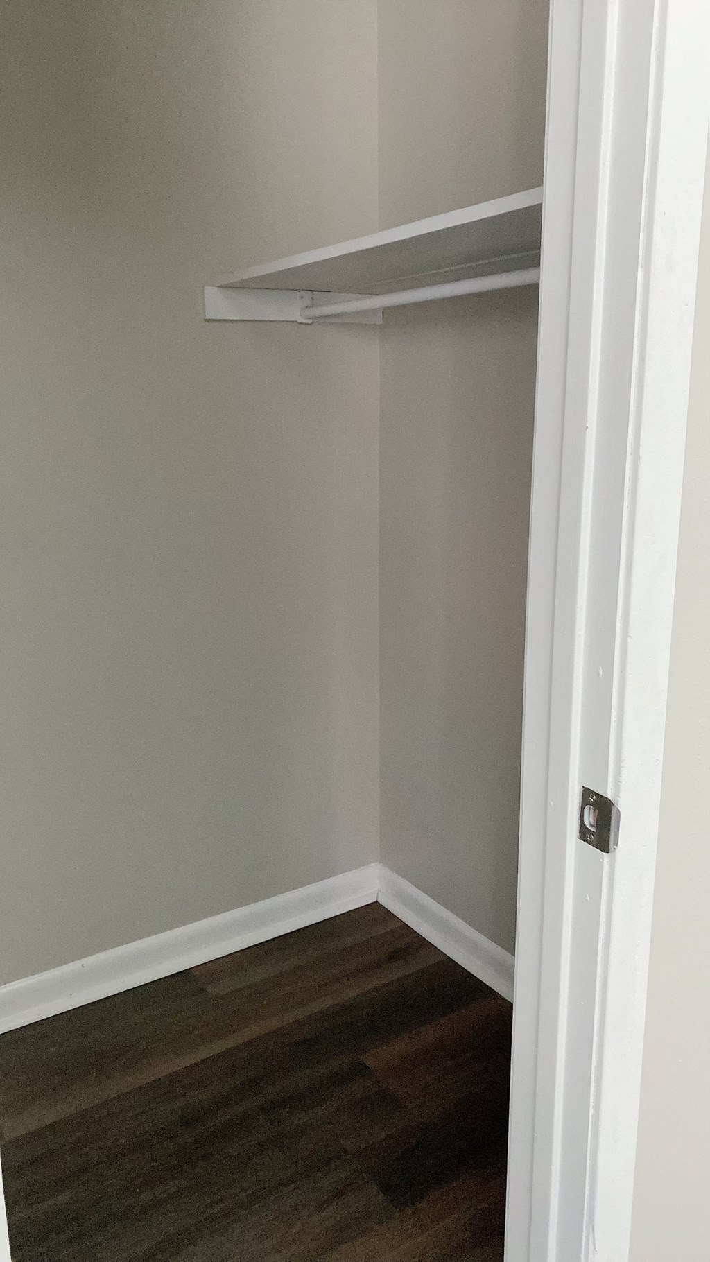 a room with a closet and a shelf on the wall