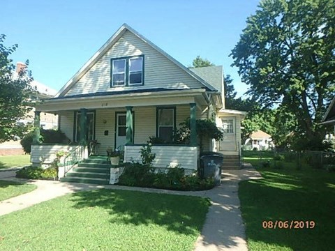 a house with a front porch and a sidewalk