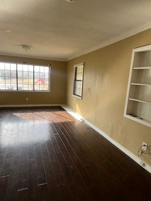 a empty room with a wood floor and a window