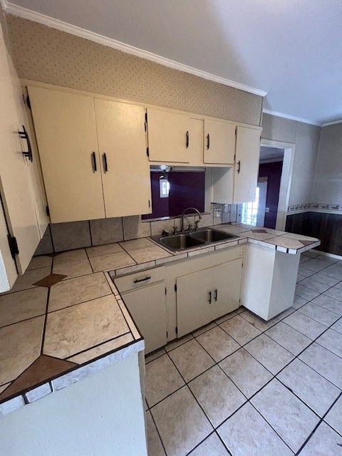 an empty kitchen with white cabinets and a sink
