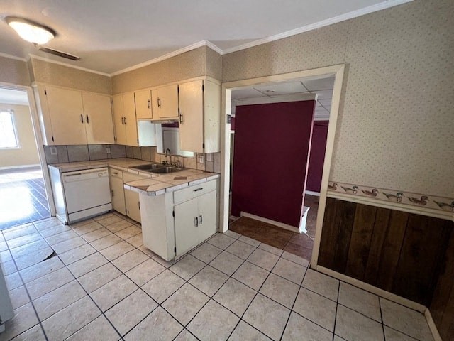 an empty kitchen with white appliances and a red door