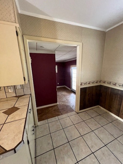 an empty kitchen and living room with a red door