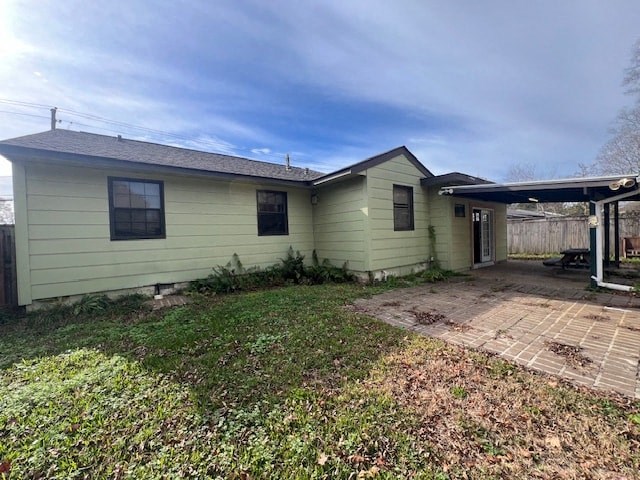 a green house with a backyard with a patio