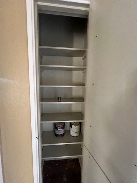 a small refrigerator with shelves in a closet
