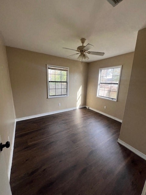 a empty living room with a ceiling fan