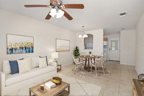 a living room with a couch and a dining room table