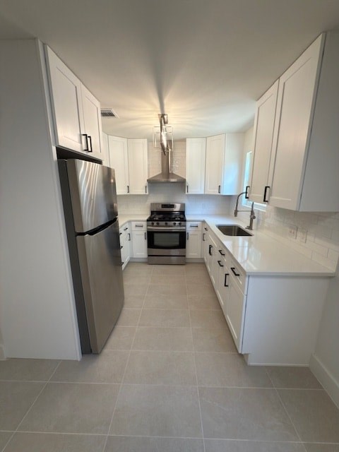 A kitchen with white cabinets and a stainless steel refrigerator.