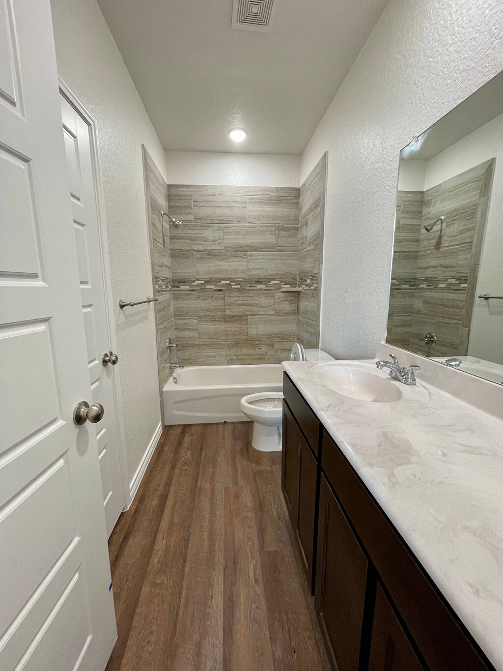 a bathroom with a shower toilet and sink