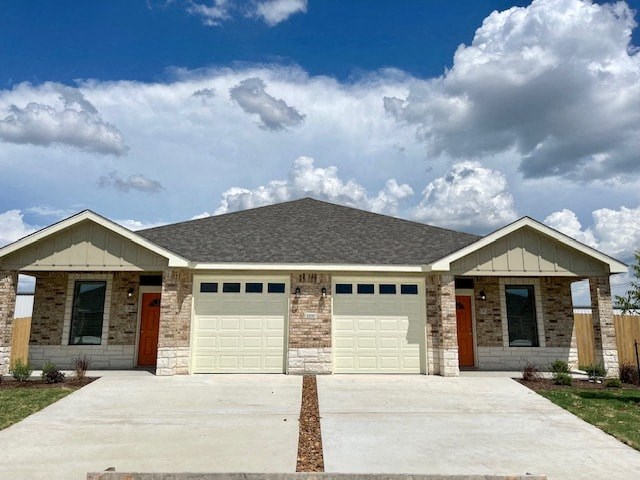 a house with a garage and a cloudy sky