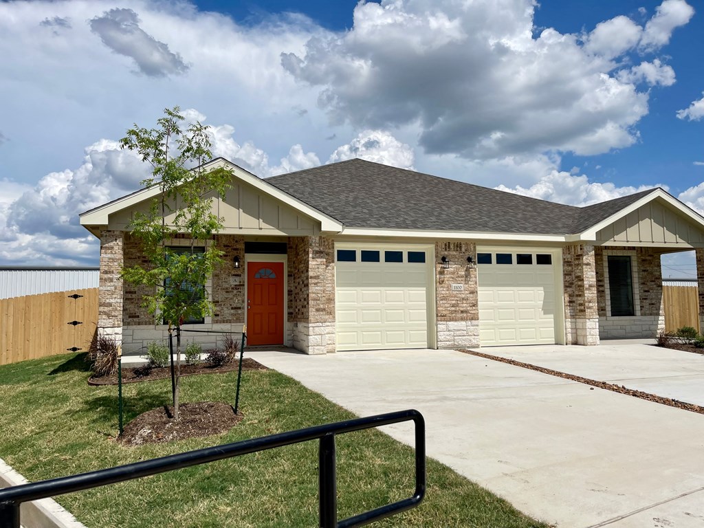 a house with a red door and a garage