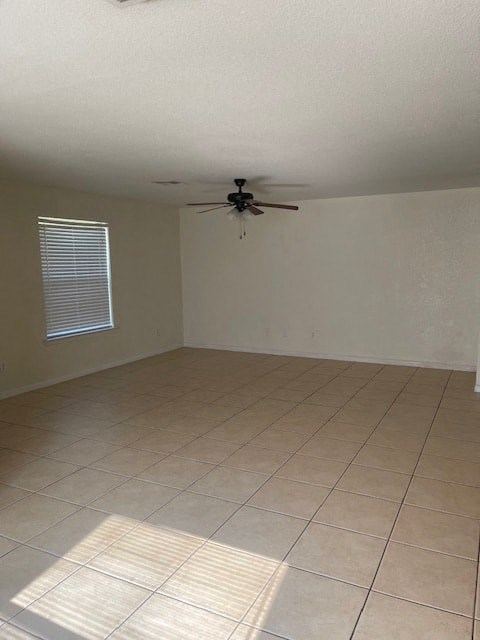 an empty living room with a ceiling fan
