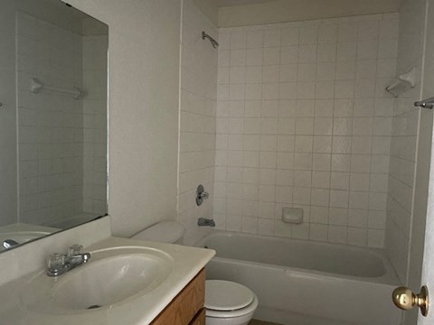a bathroom with a sink toilet and a bath tub