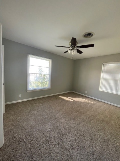 an empty room with a ceiling fan and a window