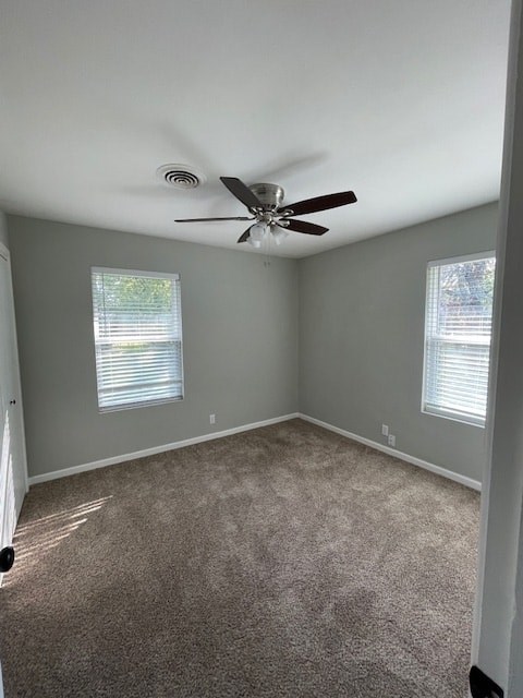an empty room with a ceiling fan in it