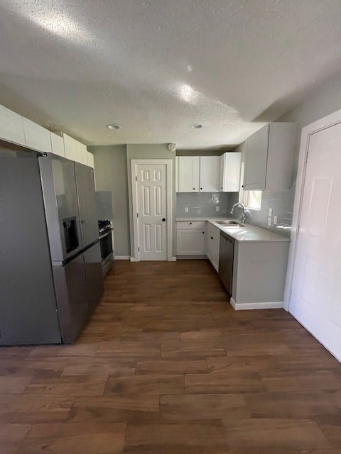 a kitchen with stainless steel appliances and a wooden floor