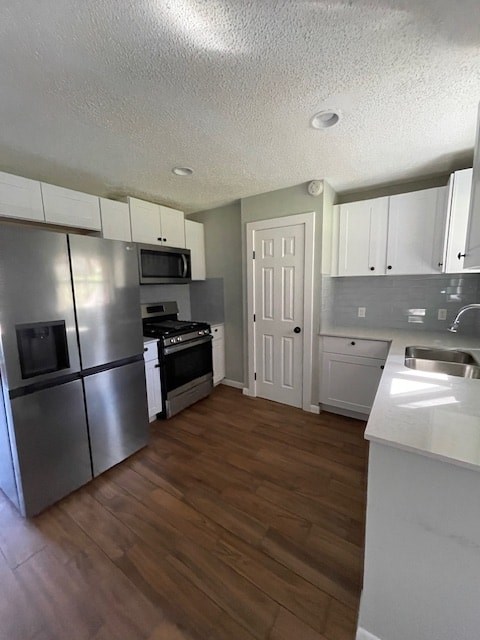 a kitchen with stainless steel appliances and white cabinets