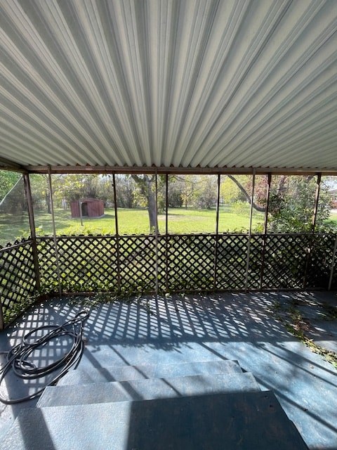 a porch with a white canopy and a fence