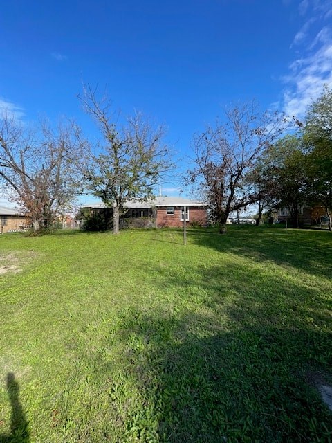 a large yard with a house in the background