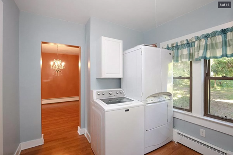 a white kitchen with a stove and a refrigerator