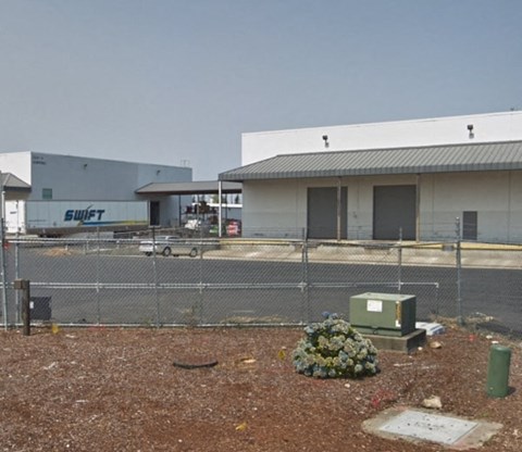 a building with a chain link fence in front of it