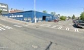 a parking lot in front of a blue building