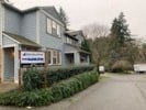 a blue house with a sign in front of it
