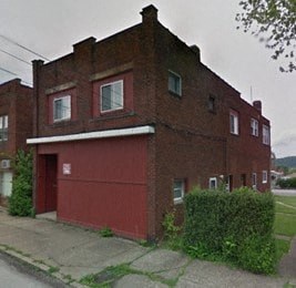 a red brick building on the side of a street