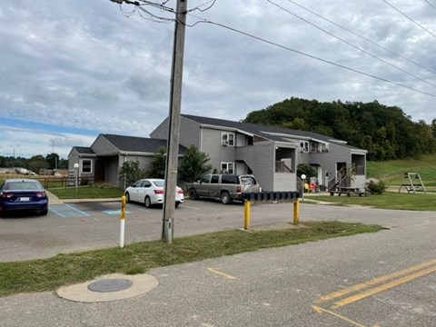 a house with cars parked in a parking lot