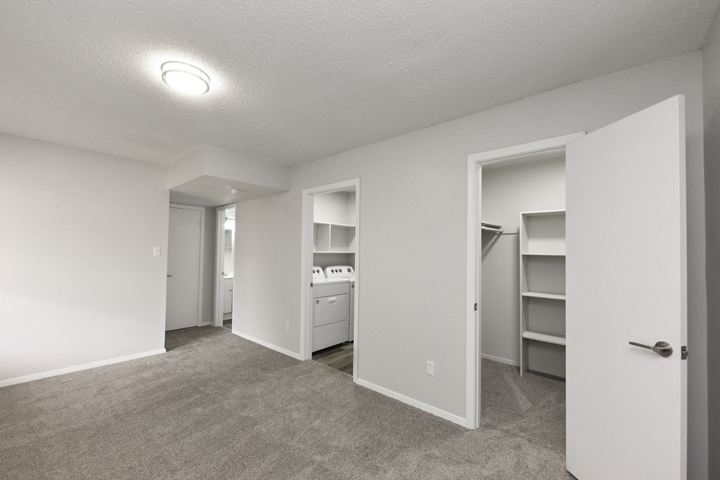 an empty bedroom with a closet and a laundry room
