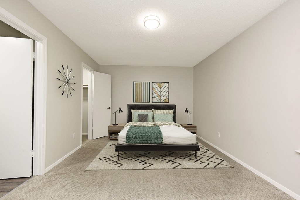 a bedroom with a bed and a door to a bathroom