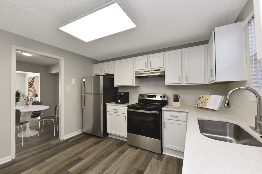 a kitchen with white cabinets and stainless steel appliances