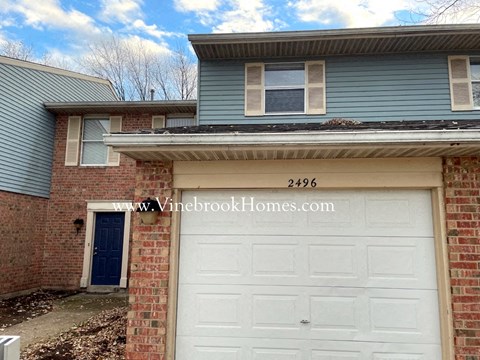 a brick house with a white garage door