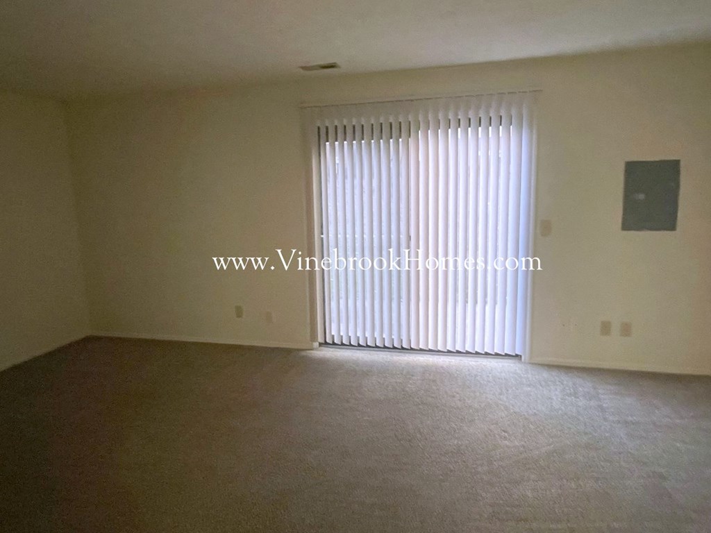 an empty living room with a sliding glass door