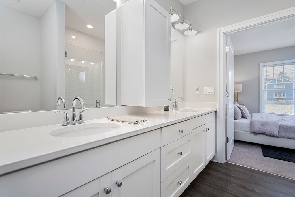 a white bathroom with a sink and a mirror