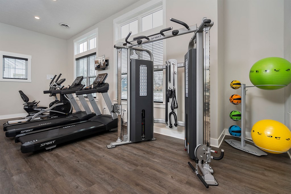a gym with treadmills and other exercise equipment at the flats at west end