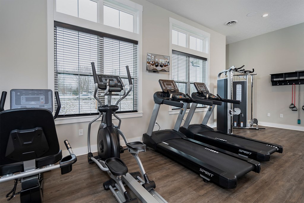 the residence apartments fitness room with exercise equipment