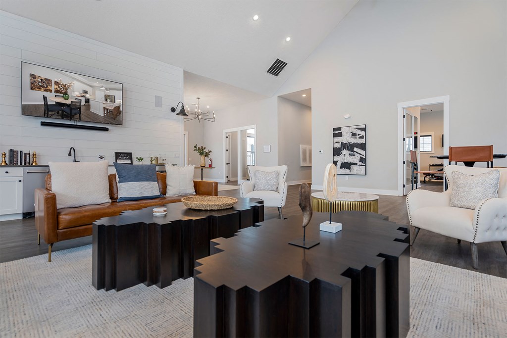 a living room with a large table and chairs