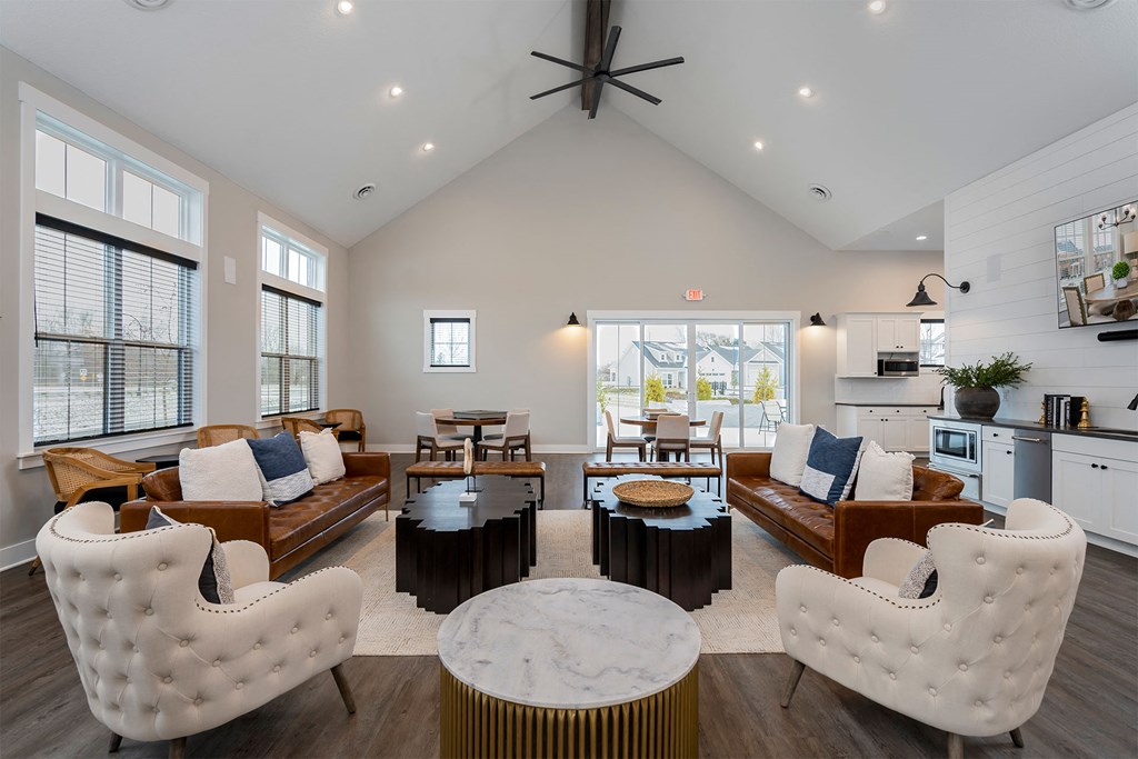 a living room with couches and chairs and a table