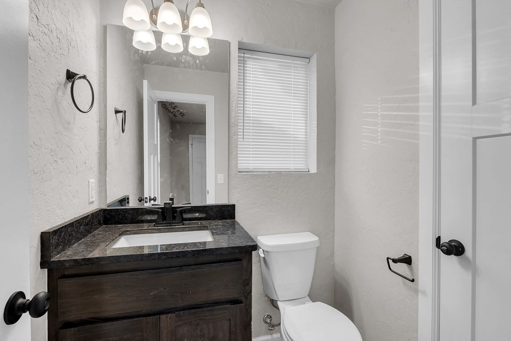 a bathroom with a sink toilet and a mirror