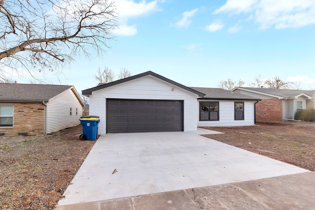 a white house with a driveway and a garage door