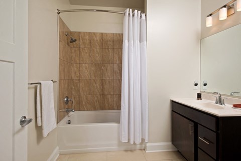 a bathroom with a shower and a sink and a bath tub