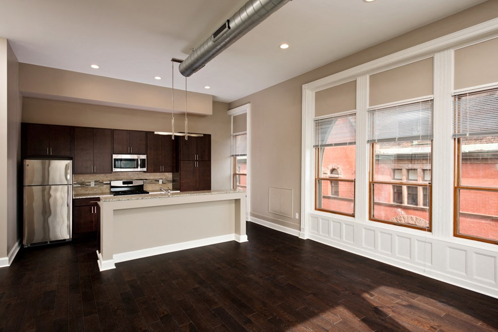 an empty kitchen with a large window and a counter
