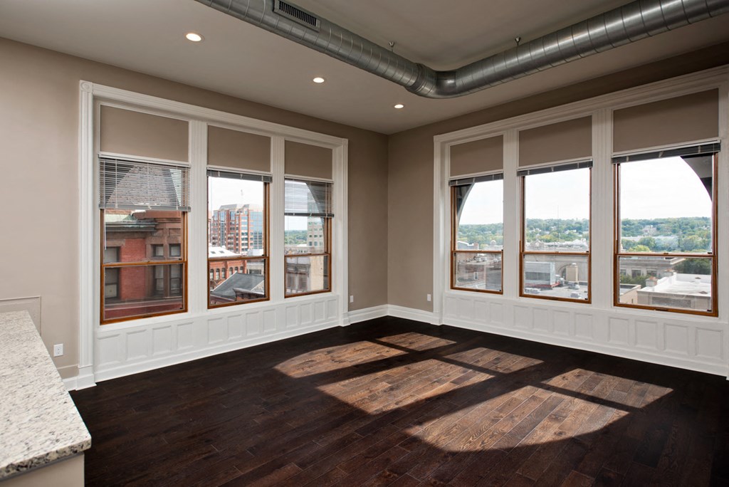 a living room with windows and a view of a city