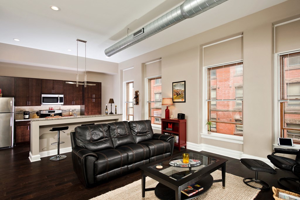 a living room with a leather couch and a coffee table
