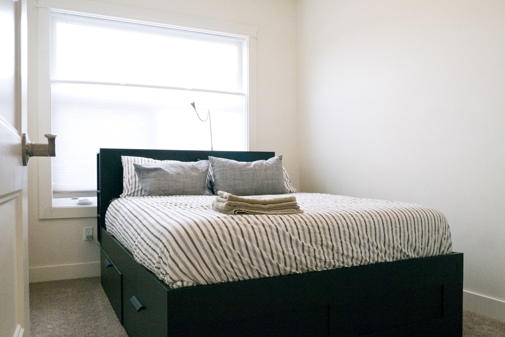 a bedroom with a bed and a window