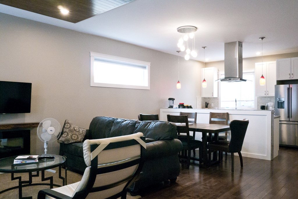 a living room with a couch and a table and a kitchen