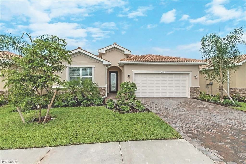 a house with a driveway and a garage door
