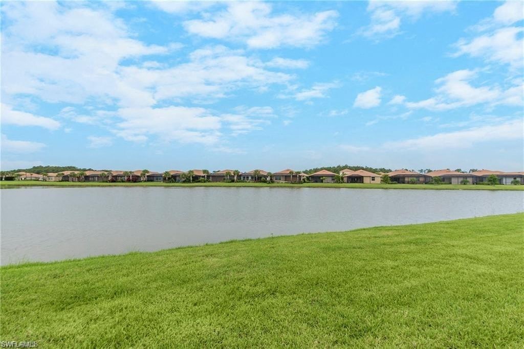 a view of a lake with houses in the distance
